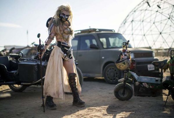 Enthusiast Desirae Hepp, dressed as "Immortan Joe," poses for a portrait during Wasteland Weekend event in California City, California September 26, 2015. The four-day event has a post-apocalyptic theme and is inspired by the Mad Max movie franchise. Picture taken September 26, 2015. REUTERS/Mario Anzuoni - RTX1SRWI
